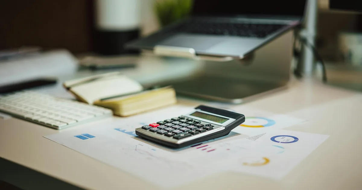 Calculator and laptop used for AWS cost estimate planning